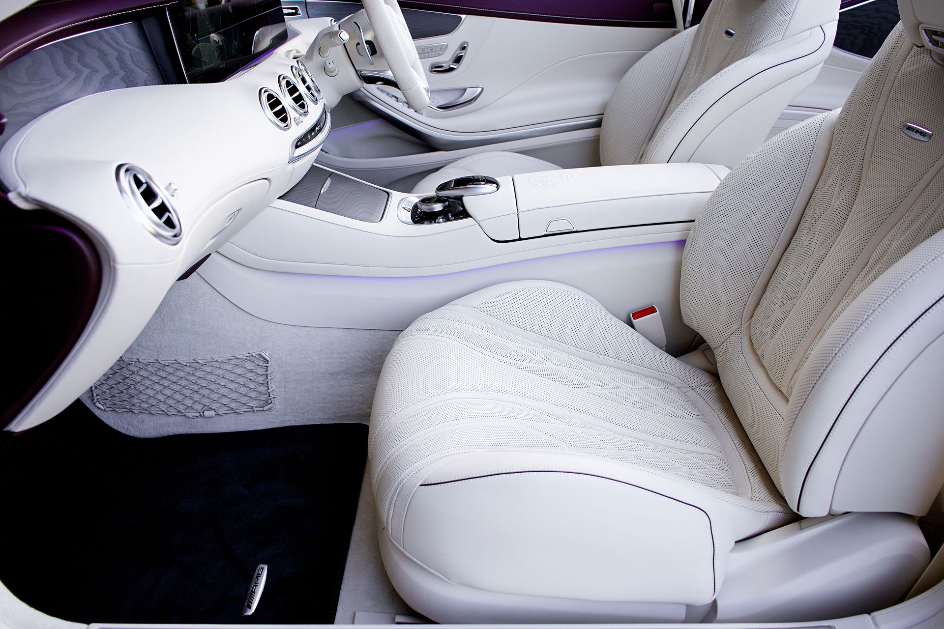 Close-up of elegant white leather interior of a luxury car with a modern dashboard.